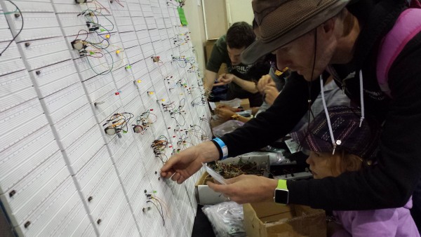 People trying out some circuits on our Breadboard Wall at Bay Area MakerFaire 2015