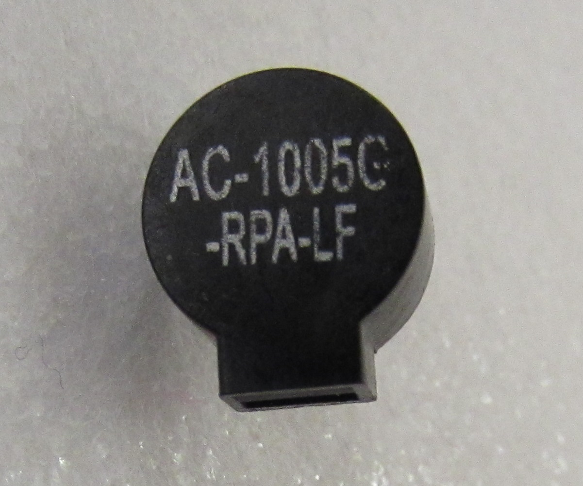 A small piezoelectric speaker.
